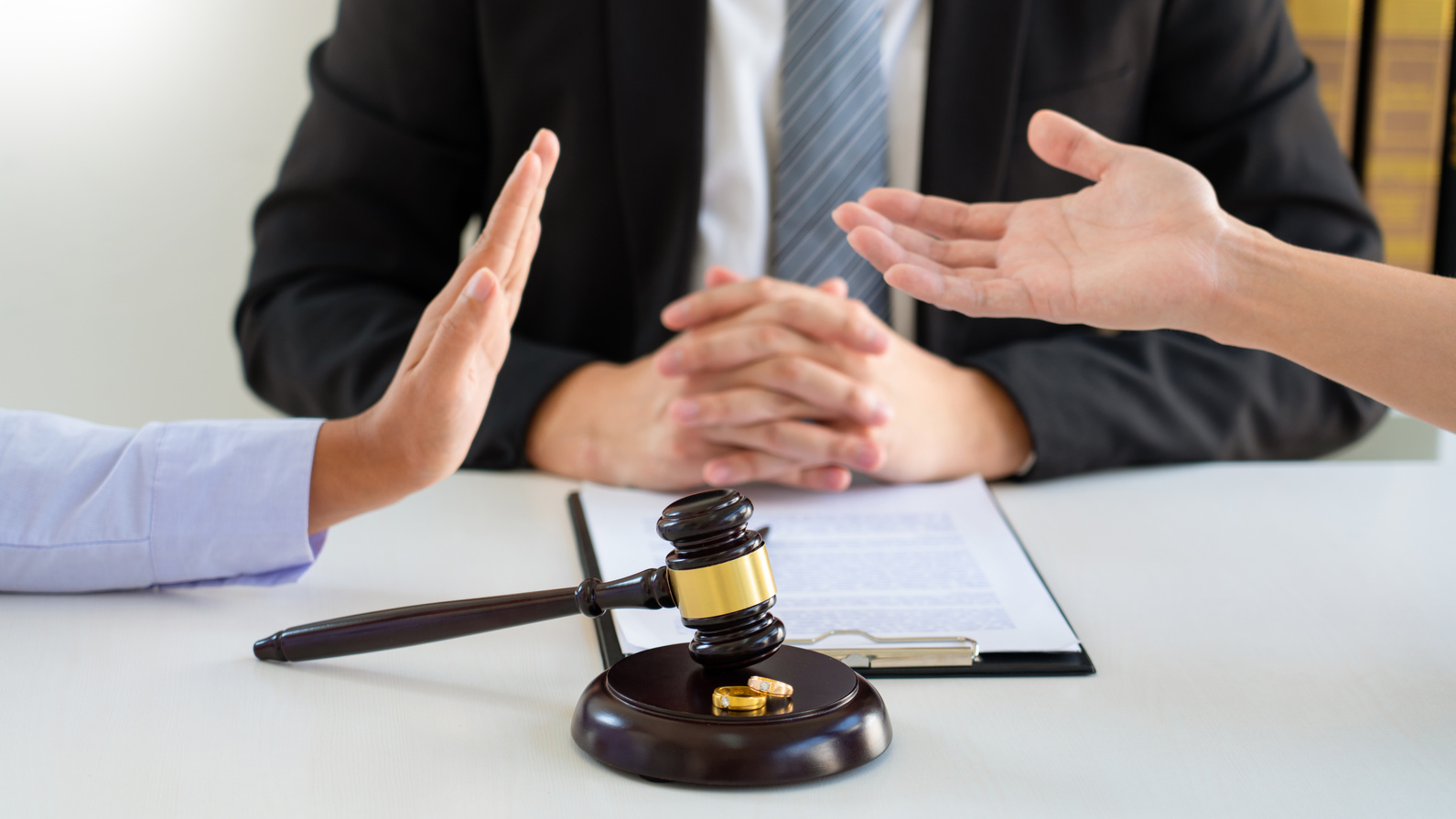 Lawyer Mediating Between Couple in Divorce Hearing